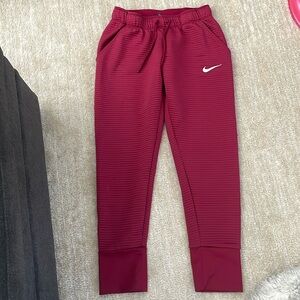 Maroon Nike sweatpants